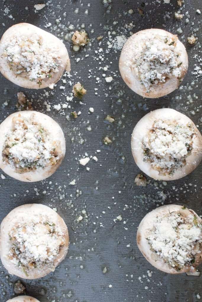 Prepped stuffed mushrooms on a baking sheet
